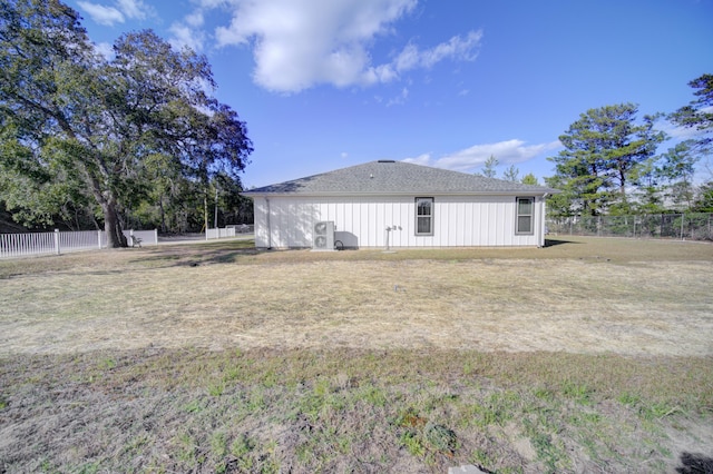 view of property exterior featuring fence and a yard