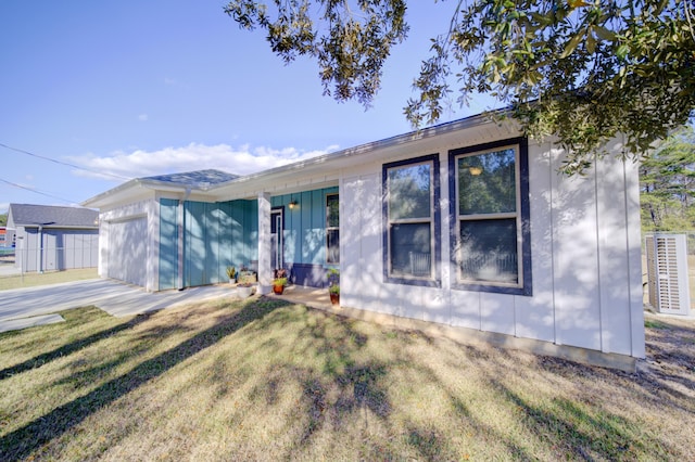 single story home featuring a front lawn, board and batten siding, and an attached garage