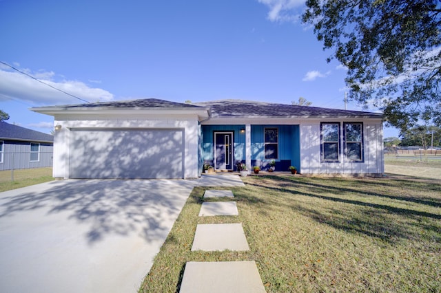 view of front facade with a garage, driveway, covered porch, and a front yard