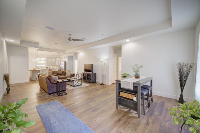 living area with light wood-type flooring and baseboards