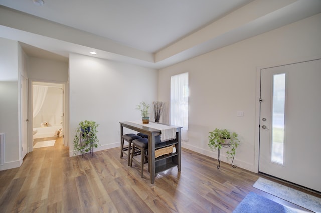 dining space with baseboards, wood finished floors, and recessed lighting