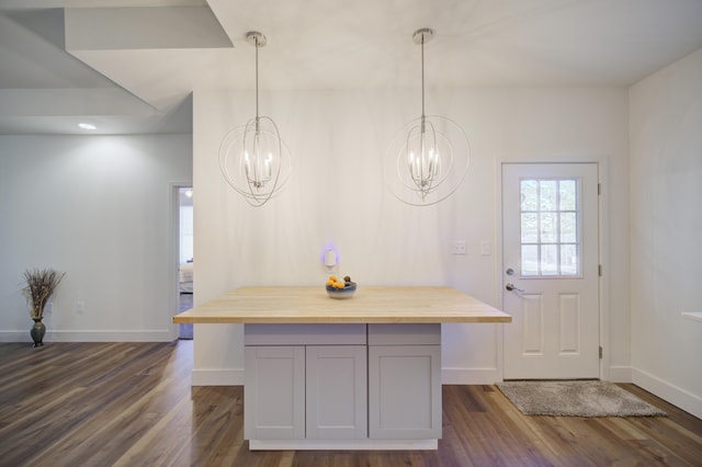 interior space with baseboards and dark wood finished floors