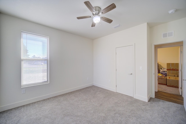 unfurnished bedroom with carpet, visible vents, ceiling fan, and baseboards