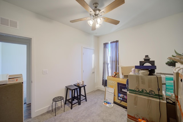 interior space with carpet floors, baseboards, visible vents, and a ceiling fan