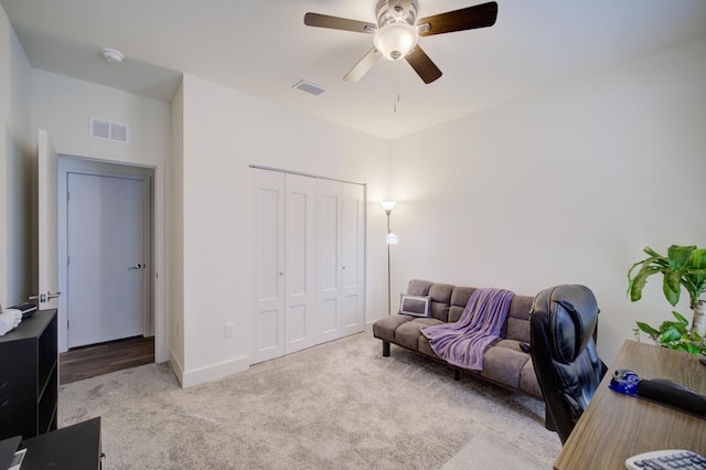 interior space with carpet, visible vents, and ceiling fan