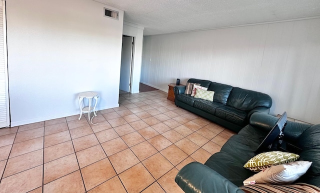 living room with a textured ceiling and light tile patterned floors