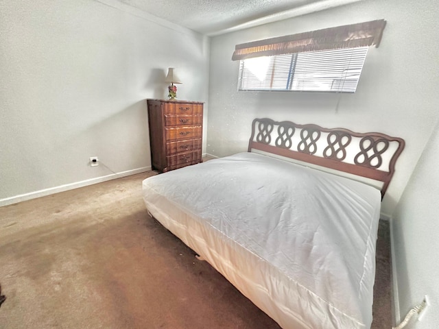 bedroom with carpet and a textured ceiling