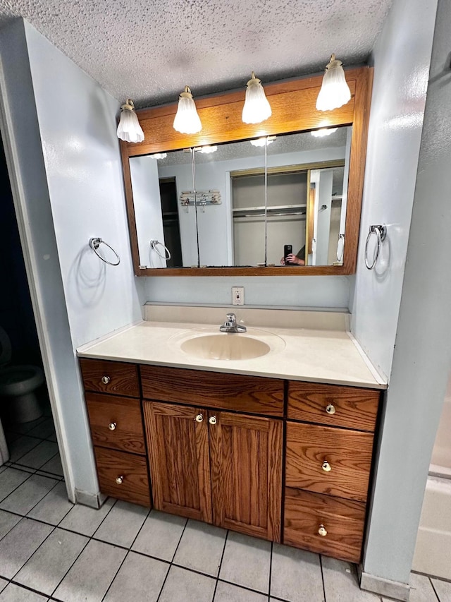 4000 Gulf Terrace Dr Unit 112, Destin, FL 32541 - bathroom with a textured ceiling, vanity, and tile patterned flooring