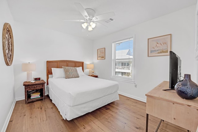 bedroom with ceiling fan and light hardwood / wood-style floors