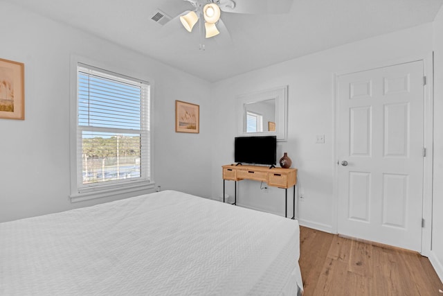 bedroom with ceiling fan and light hardwood / wood-style floors