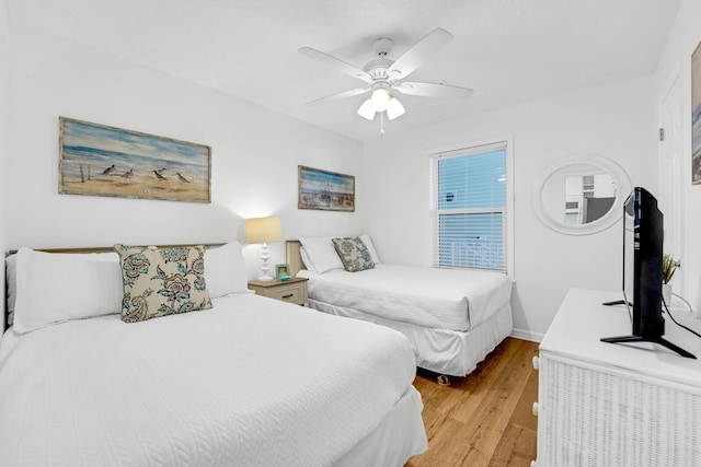 bedroom featuring ceiling fan and light hardwood / wood-style floors
