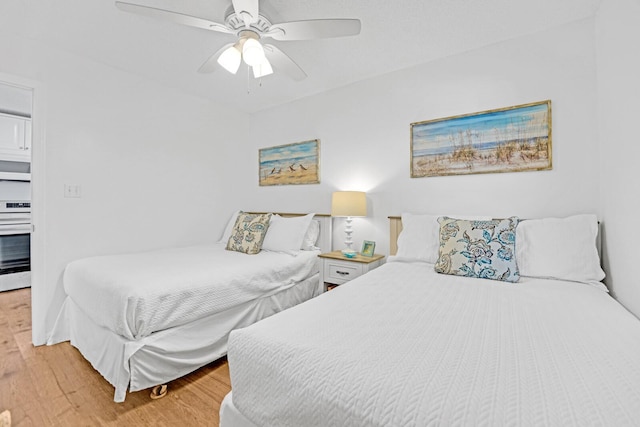 bedroom with ceiling fan and hardwood / wood-style floors