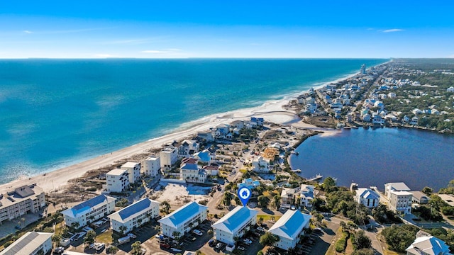 birds eye view of property with a water view and a view of the beach