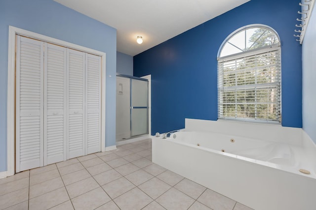 bathroom with a stall shower, a closet, a whirlpool tub, and tile patterned floors