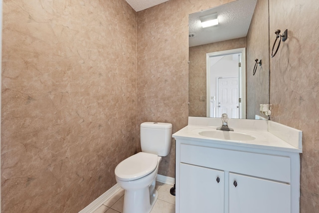 half bath featuring toilet, tile patterned flooring, a textured ceiling, and vanity