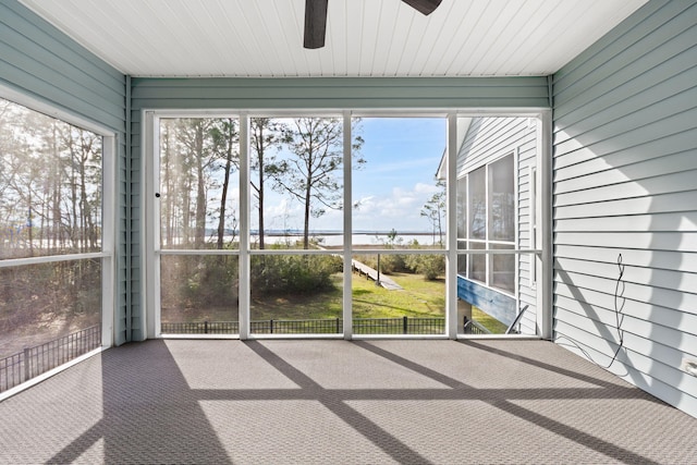 unfurnished sunroom with a ceiling fan