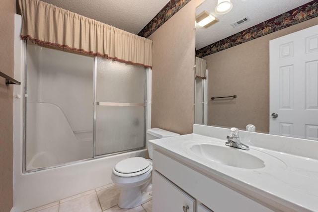 bathroom featuring toilet, tile patterned flooring, visible vents, and a textured ceiling