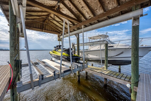 dock area with a water view and boat lift