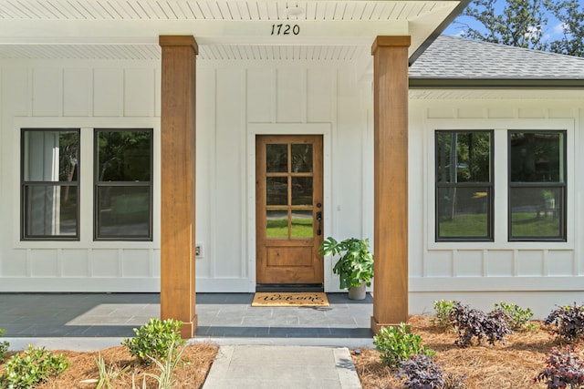 1720 25th St, Niceville, FL 32578 - view of exterior entry featuring roof with shingles and board and batten siding