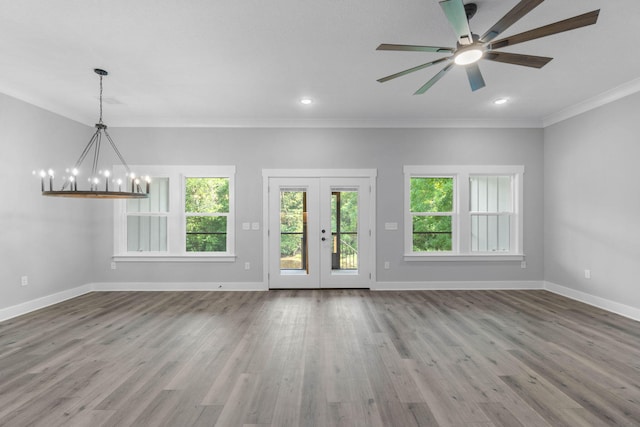 1720 25th St, Niceville, FL 32578 - unfurnished living room with baseboards, a chandelier, ceiling fan, french doors, and ornamental molding