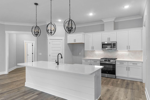 1720 25th St, Niceville, FL 32578 - kitchen with appliances with stainless steel finishes, crown molding, a chandelier, tasteful backsplash, and white cabinets