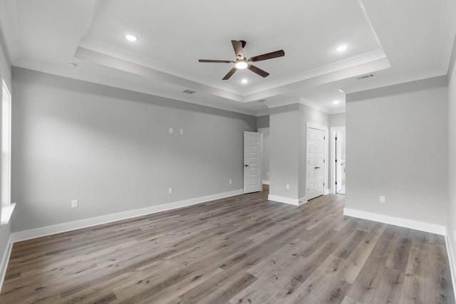 1720 25th St, Niceville, FL 32578 - empty room featuring a raised ceiling, a ceiling fan, crown molding, wood finished floors, and recessed lighting