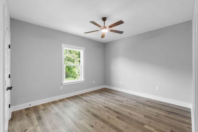 1720 25th St, Niceville, FL 32578 - empty room with ceiling fan, wood finished floors, and baseboards