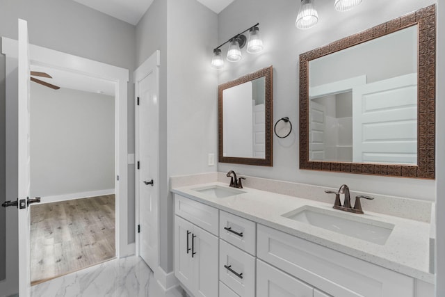 1720 25th St, Niceville, FL 32578 - bathroom with double vanity, baseboards, and a ceiling fan