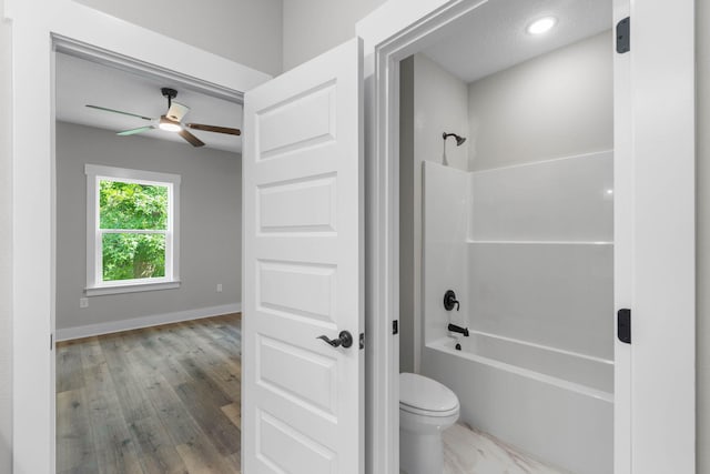 1720 25th St, Niceville, FL 32578 - full bathroom with shower / washtub combination, ceiling fan, toilet, baseboards, and wood finished floors