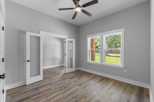 1720 25th St, Niceville, FL 32578 - spare room with french doors, wood finished floors, ceiling fan, and baseboards