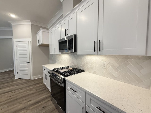 1720 25th St, Niceville, FL 32578 - kitchen with stainless steel appliances, ornamental molding, dark wood finished floors, baseboards, and decorative backsplash