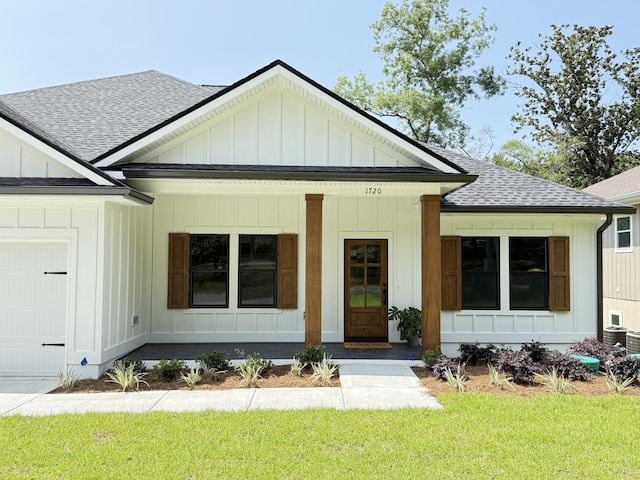 1720 25th St, Niceville, FL 32578 - modern farmhouse featuring a shingled roof, board and batten siding, covered porch, a garage, and a front lawn