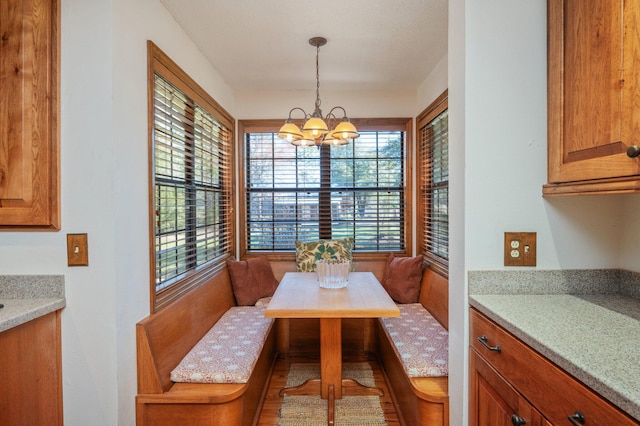 dining area featuring breakfast area and a notable chandelier