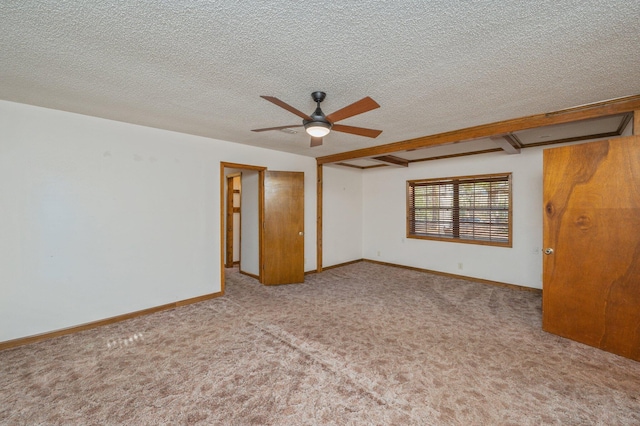 unfurnished room with light carpet, a ceiling fan, baseboards, and a textured ceiling