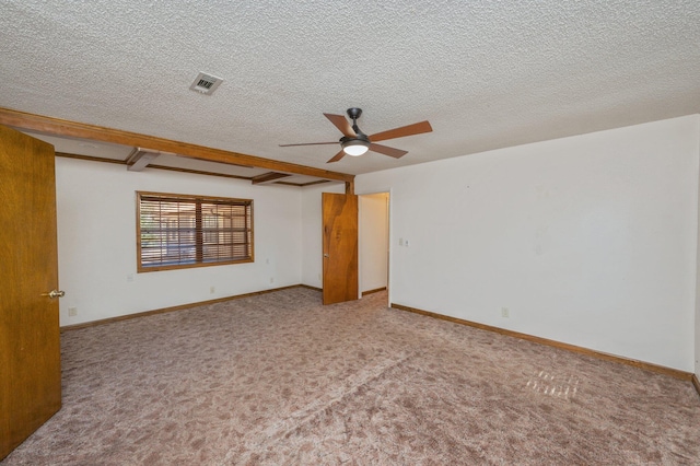 empty room with light carpet, a textured ceiling, visible vents, and baseboards