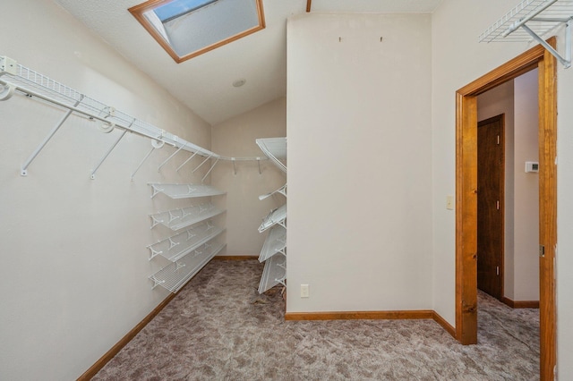 walk in closet featuring lofted ceiling and light carpet