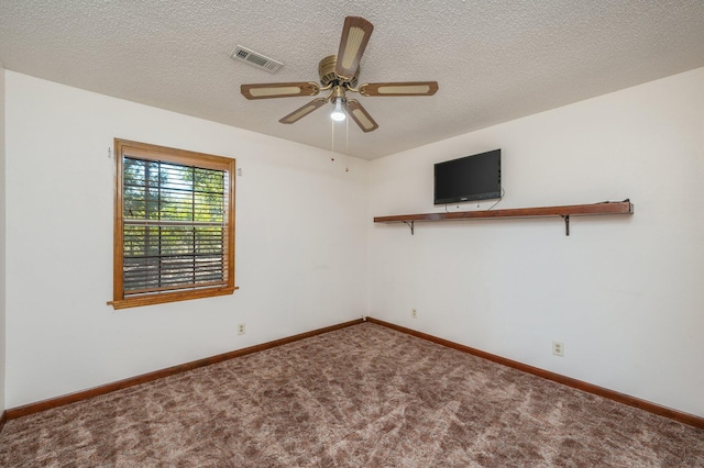 carpeted spare room featuring visible vents, ceiling fan, a textured ceiling, and baseboards