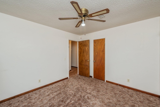 interior space featuring carpet floors, baseboards, and a textured ceiling