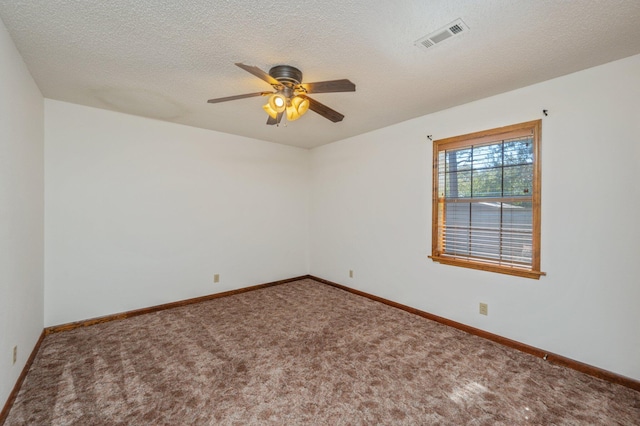 carpeted spare room featuring baseboards, visible vents, ceiling fan, and a textured ceiling