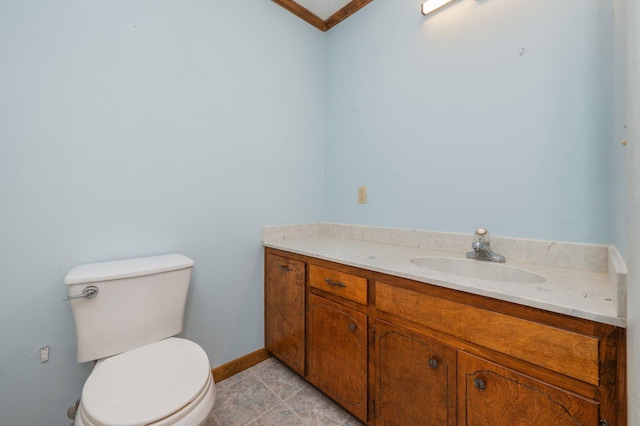 bathroom featuring toilet, tile patterned floors, baseboards, and vanity