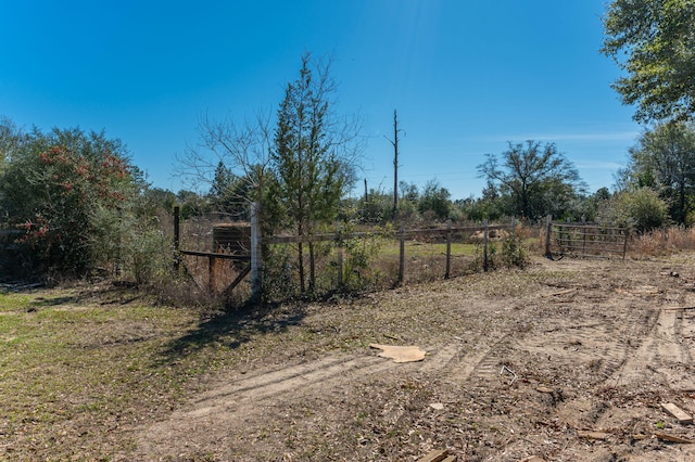 exterior space featuring fence and a rural view