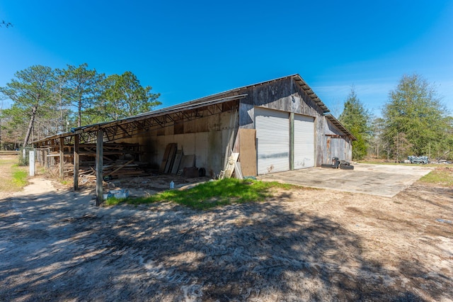 garage with a detached garage and driveway