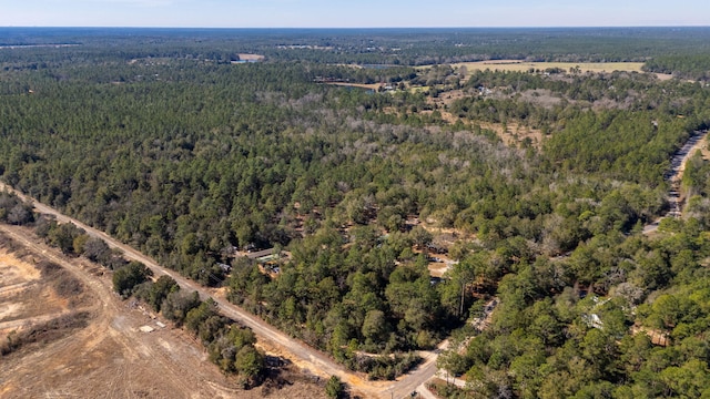 birds eye view of property with a view of trees