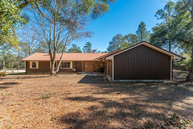 view of front of property with metal roof and board and batten siding