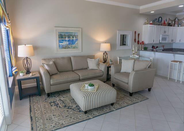 living room with light tile patterned flooring and crown molding