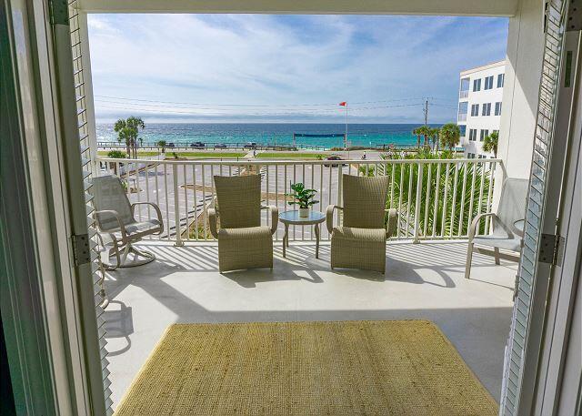 balcony featuring a water view and a beach view