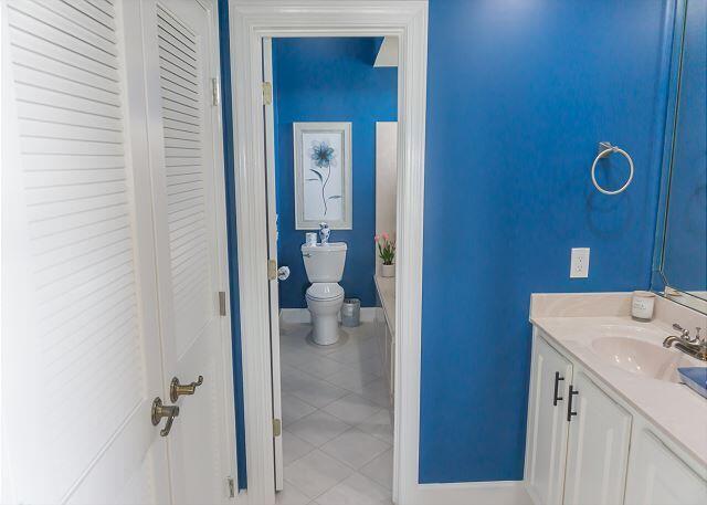 bathroom featuring toilet, tile patterned flooring, baseboards, and vanity