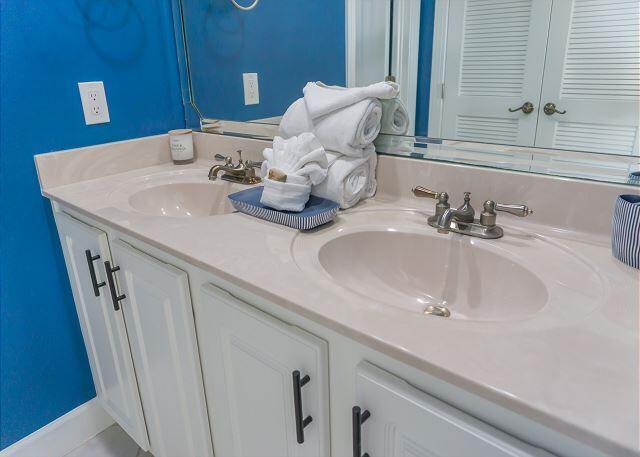 full bathroom featuring a sink and double vanity