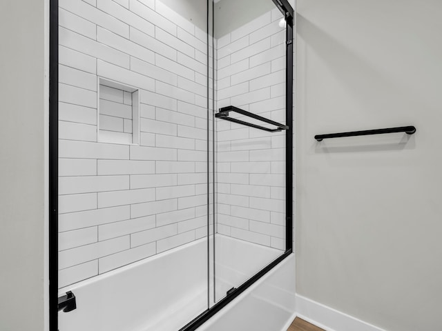 bathroom with shower / bath combination with glass door