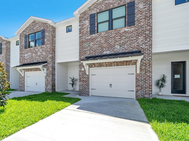 view of property featuring a front lawn and a garage